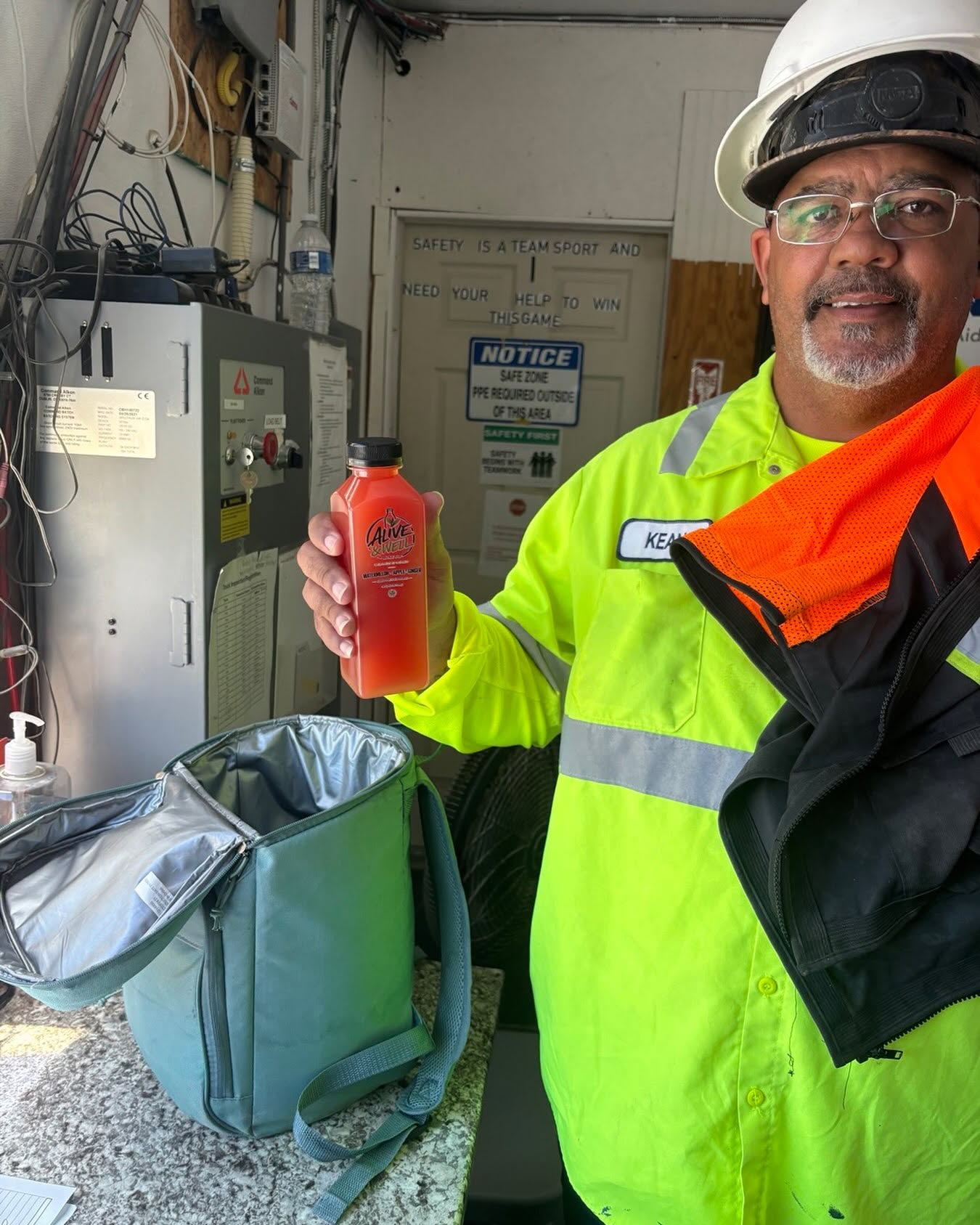 Worksite customer holding a bottle of watermelon ginger juice