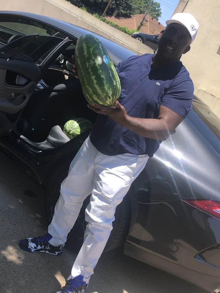 Customer loading a big watermelon into his car